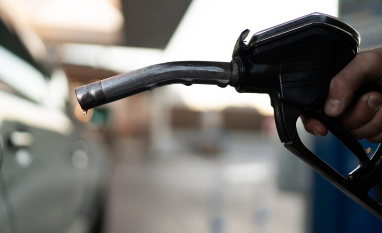 Fuel nozzle filling up car with fuel