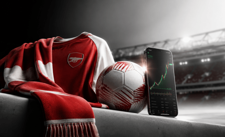 Arsenal-inspired football scene with a crypto trading screen showing Bitpanda partnership after Premier League win